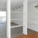 open shelves between living room and kitchen area
